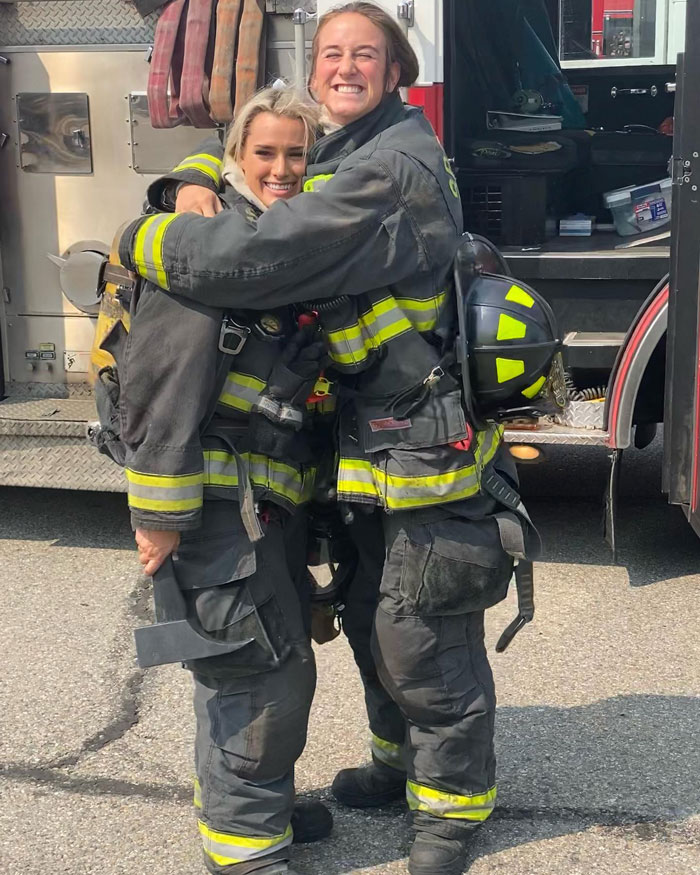 2 women fire fighters hugging